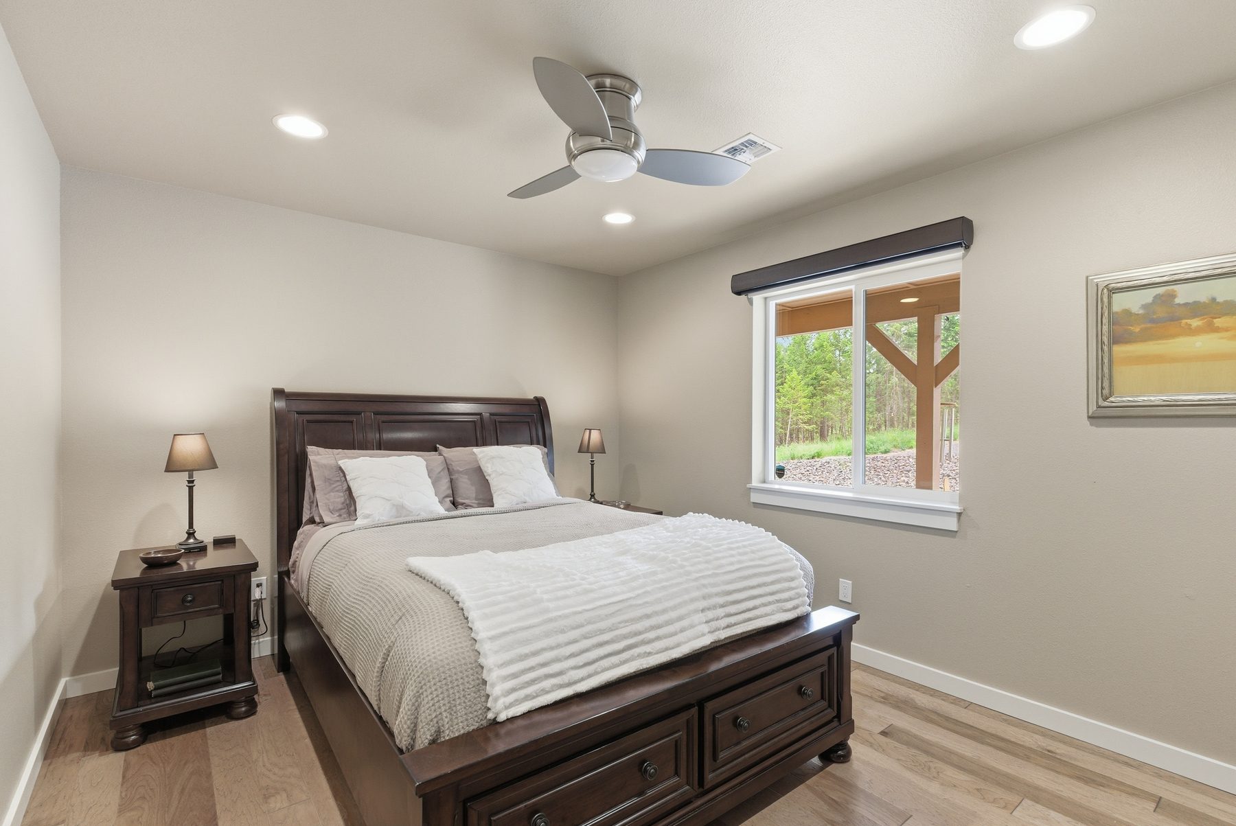 Bright bedroom with vaulted ceiling and pine view