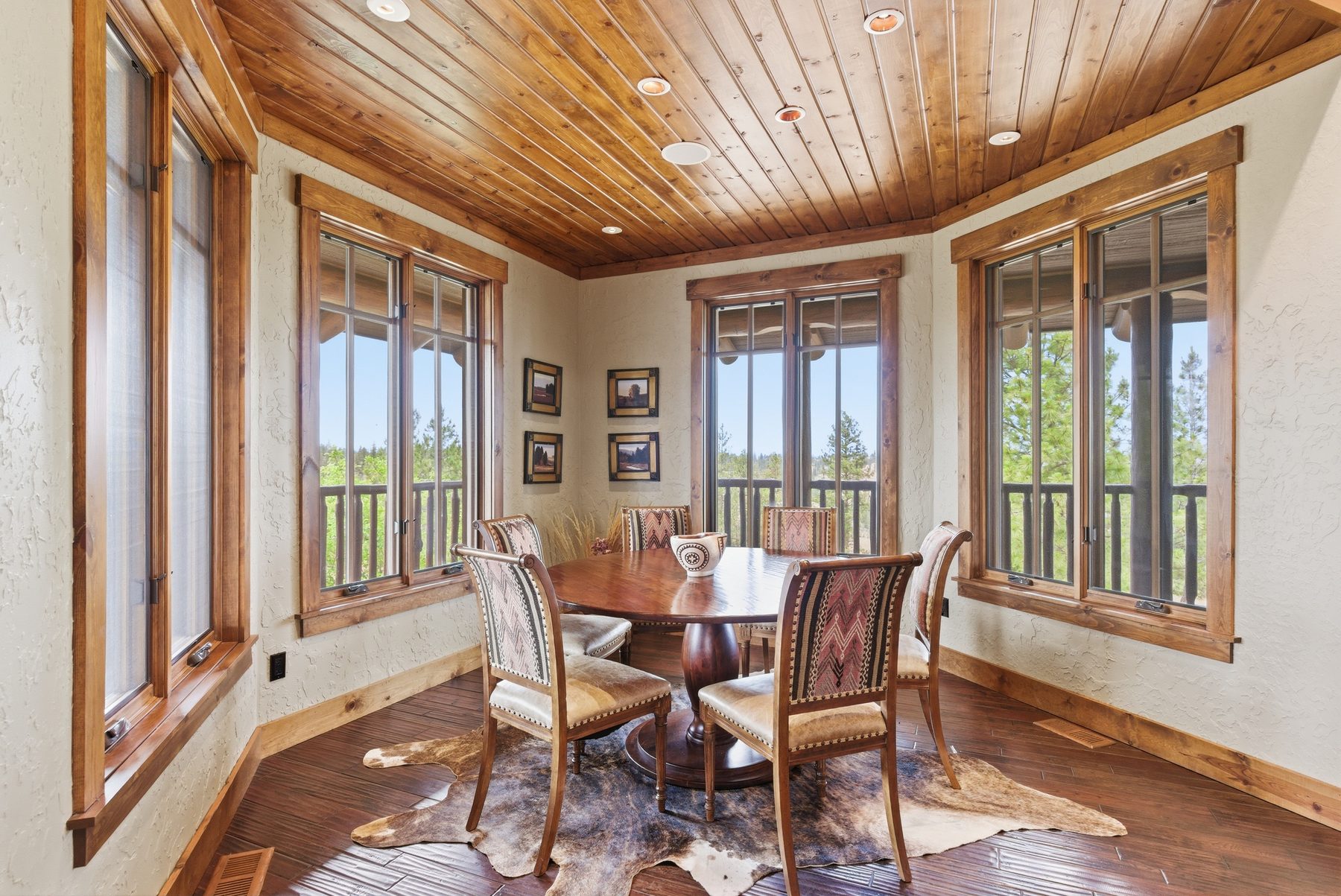 Dining room in a bay window with knotty pine ceiling