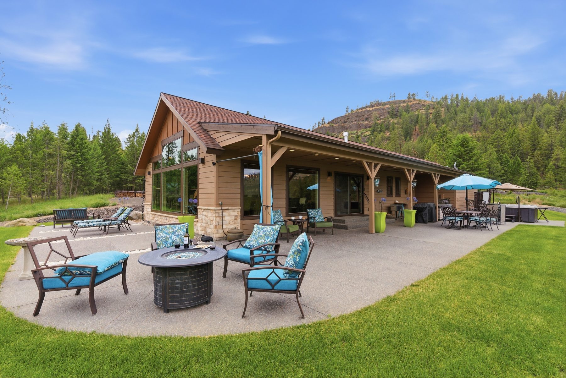 Covered outdoor patio with fire pit and valley view