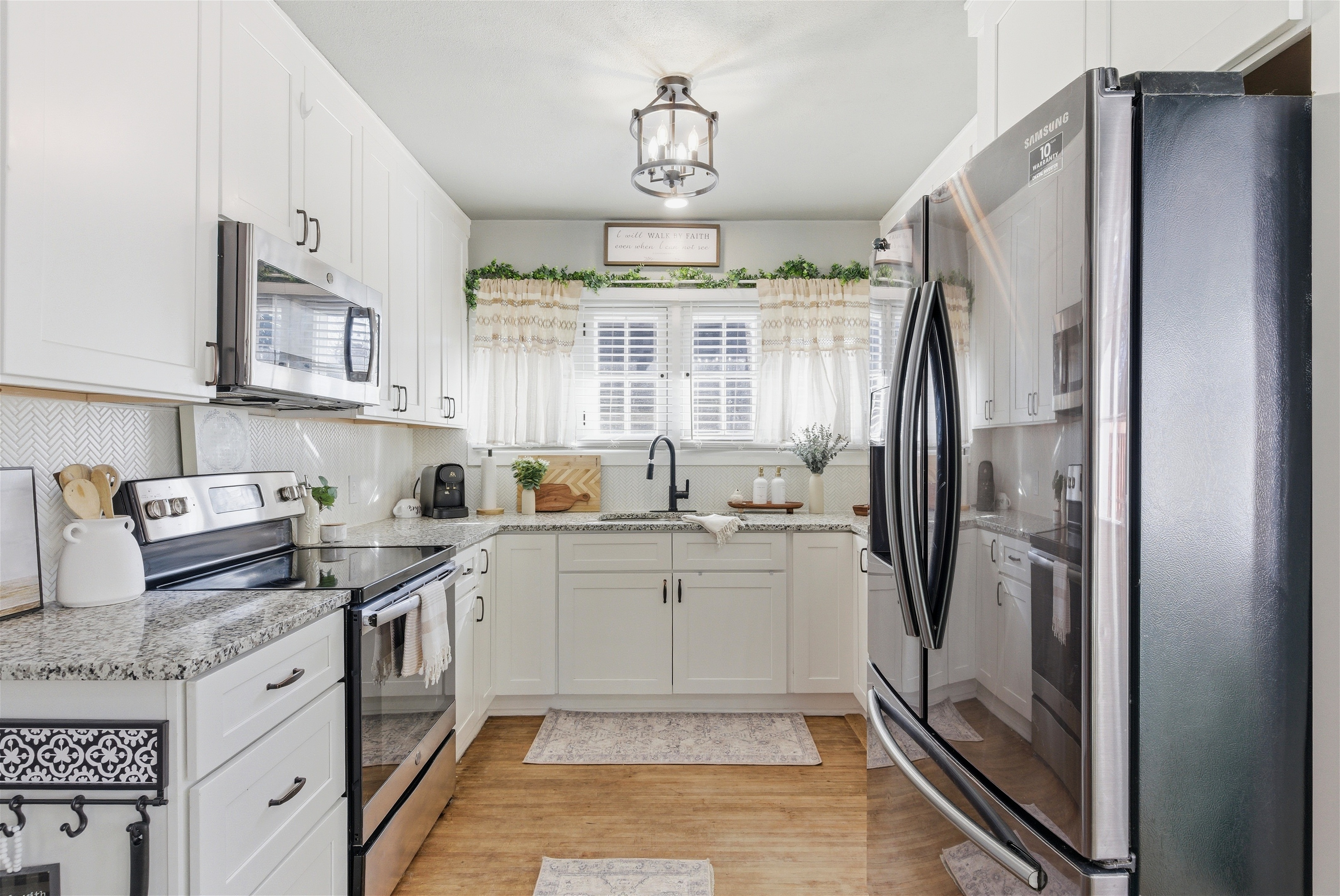 White kitchen with stainless appliances