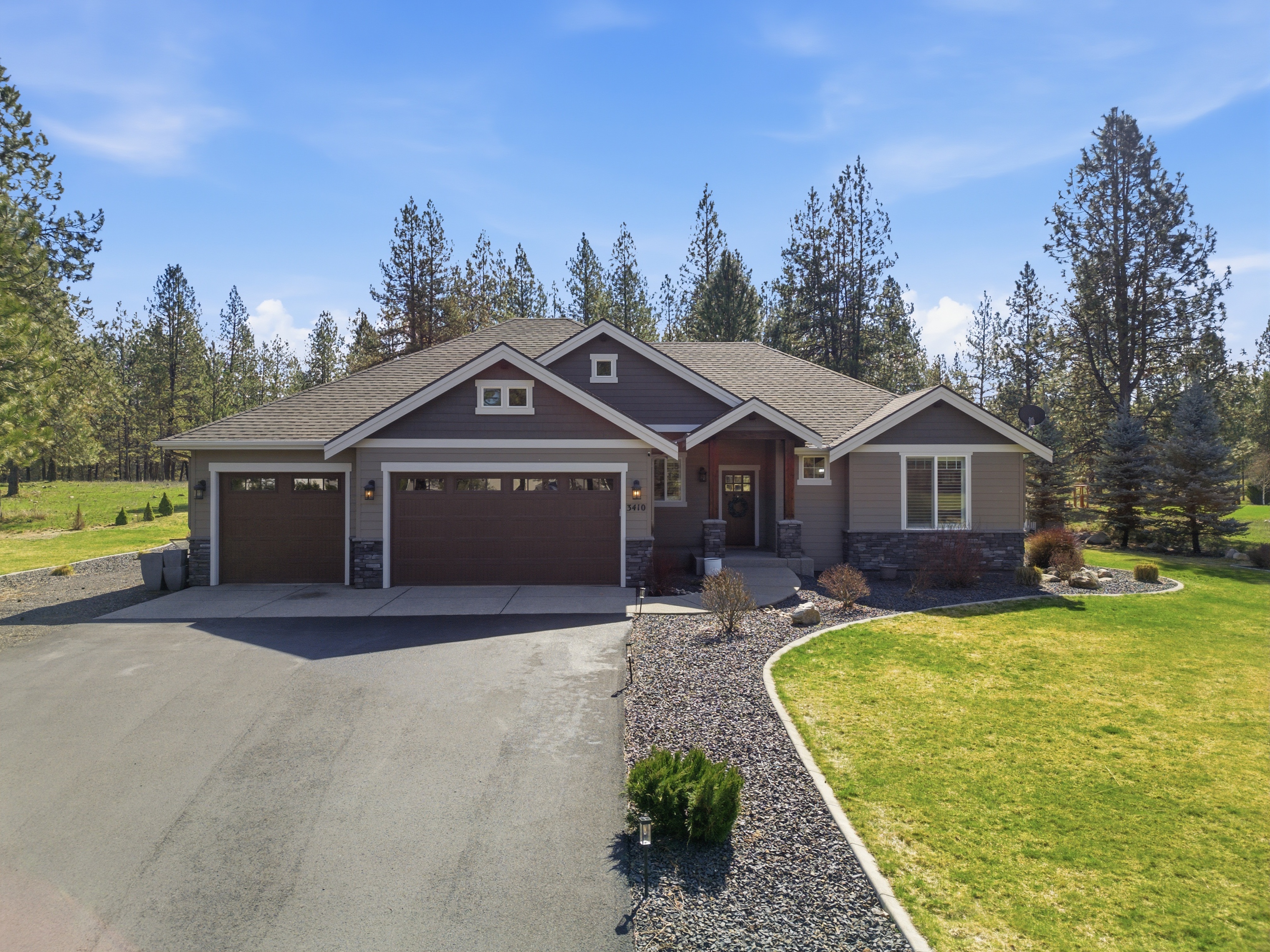 Craftsman home exterior with pine trees
