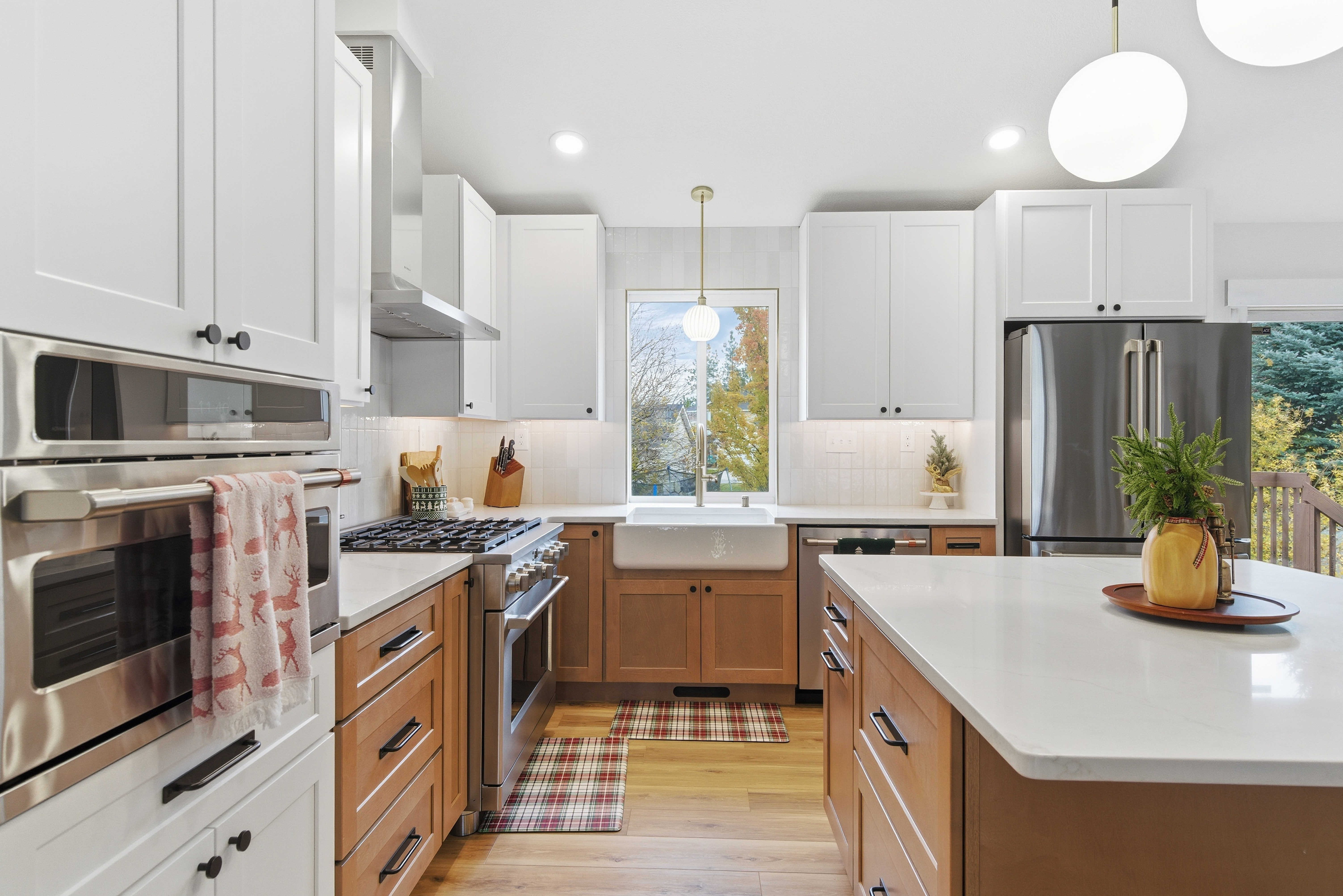 Warm farmhouse kitchen with white upper cabinets and farmhouse sink
